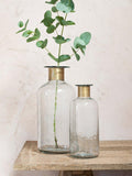 Nkuku Chara hammered glass bottle vase in Clear, imported from the UK