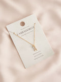 Gold tone initial necklace with letter pendant, UK version
