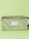 Flat Lay Co. sage green velvet makeup bag (British brand)