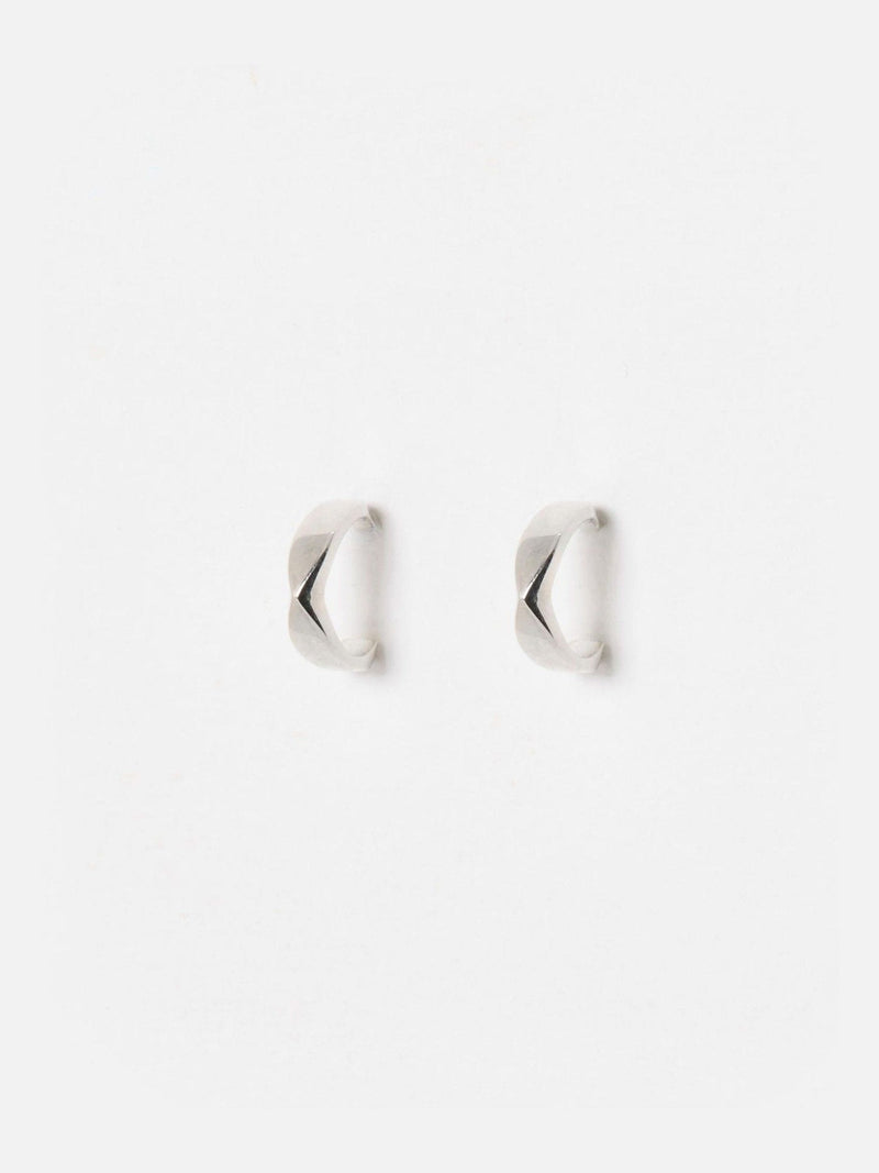 Oliver Bonas sterling silver huggie earrings with faceted surface, imported from the UK