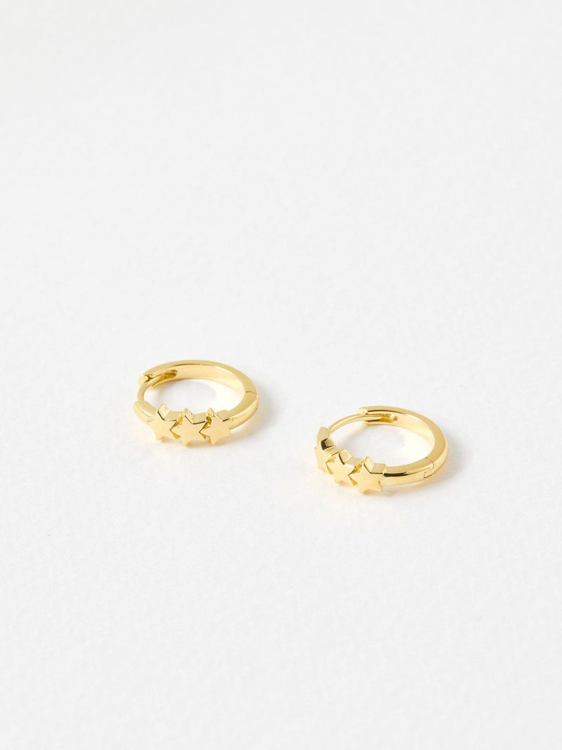 Oliver Bonas gold tone tiny triple star huggie earrings, imported from the UK