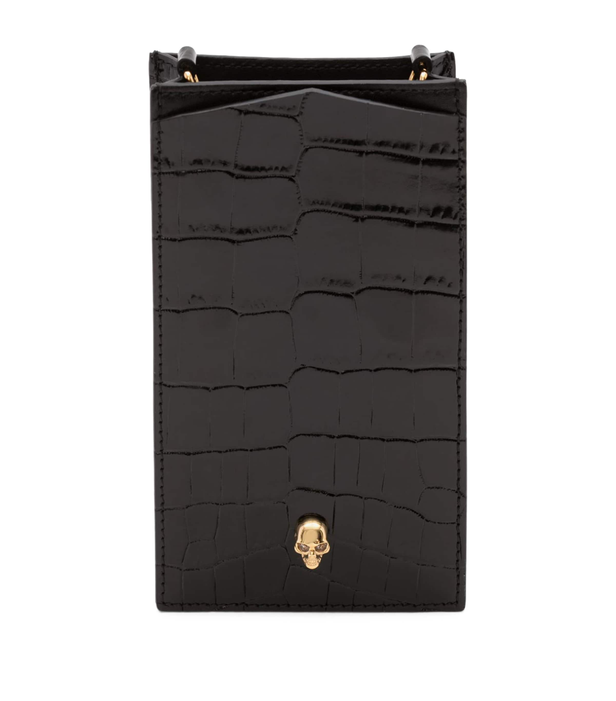 McQueen skull-embellished croc-embossed leather phone case, imported from the UK