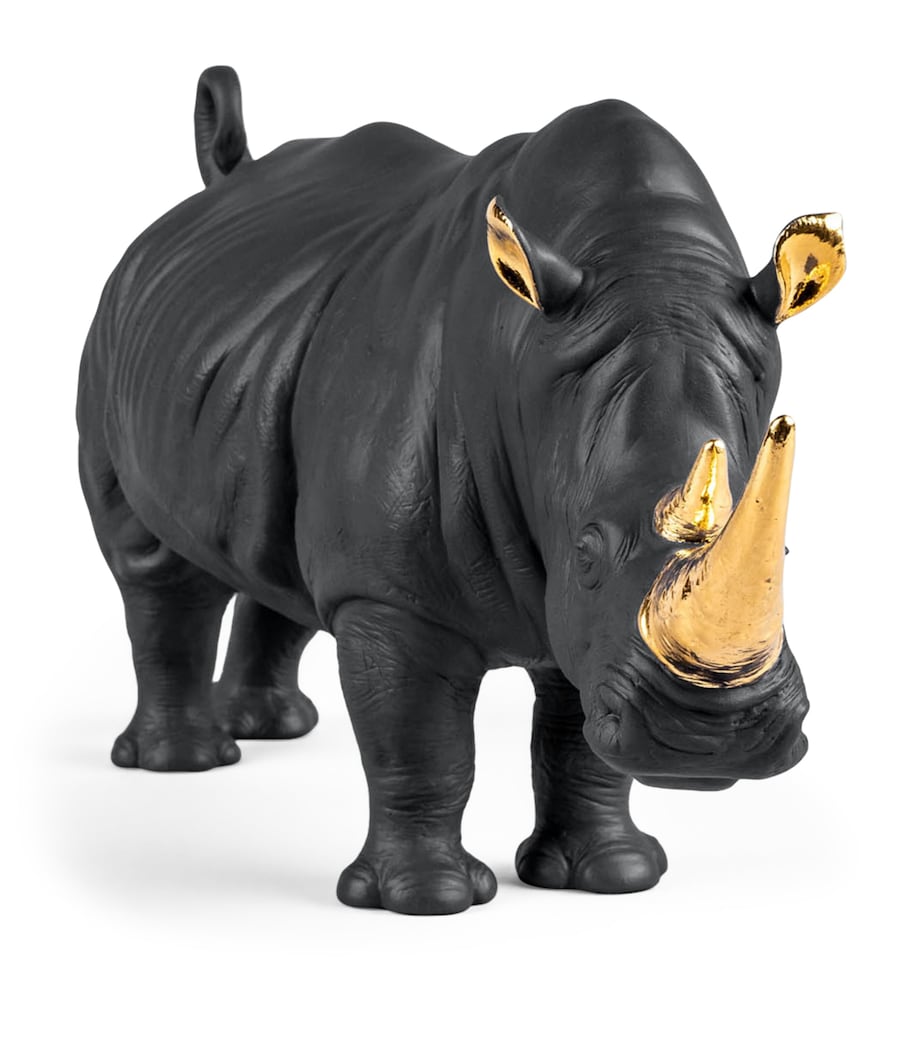 Lladró porcelain rhino figurine with gold accents, 22cm high, UK version
