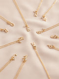 Gold tone initial necklace with letter pendant, UK version