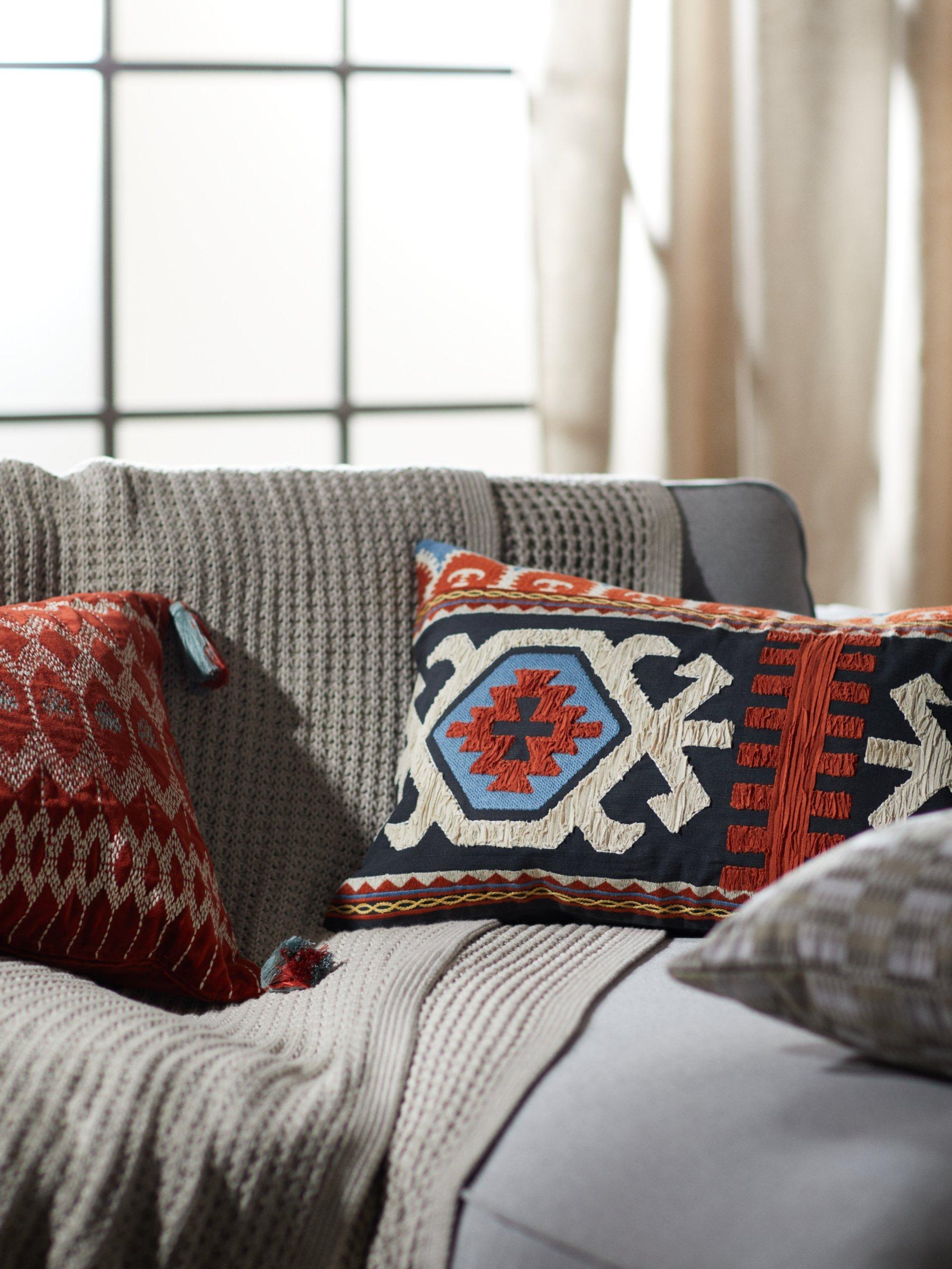 John Lewis Kuva velvet bolster cushion with embroidery and tassels in Red Brick, UK version
