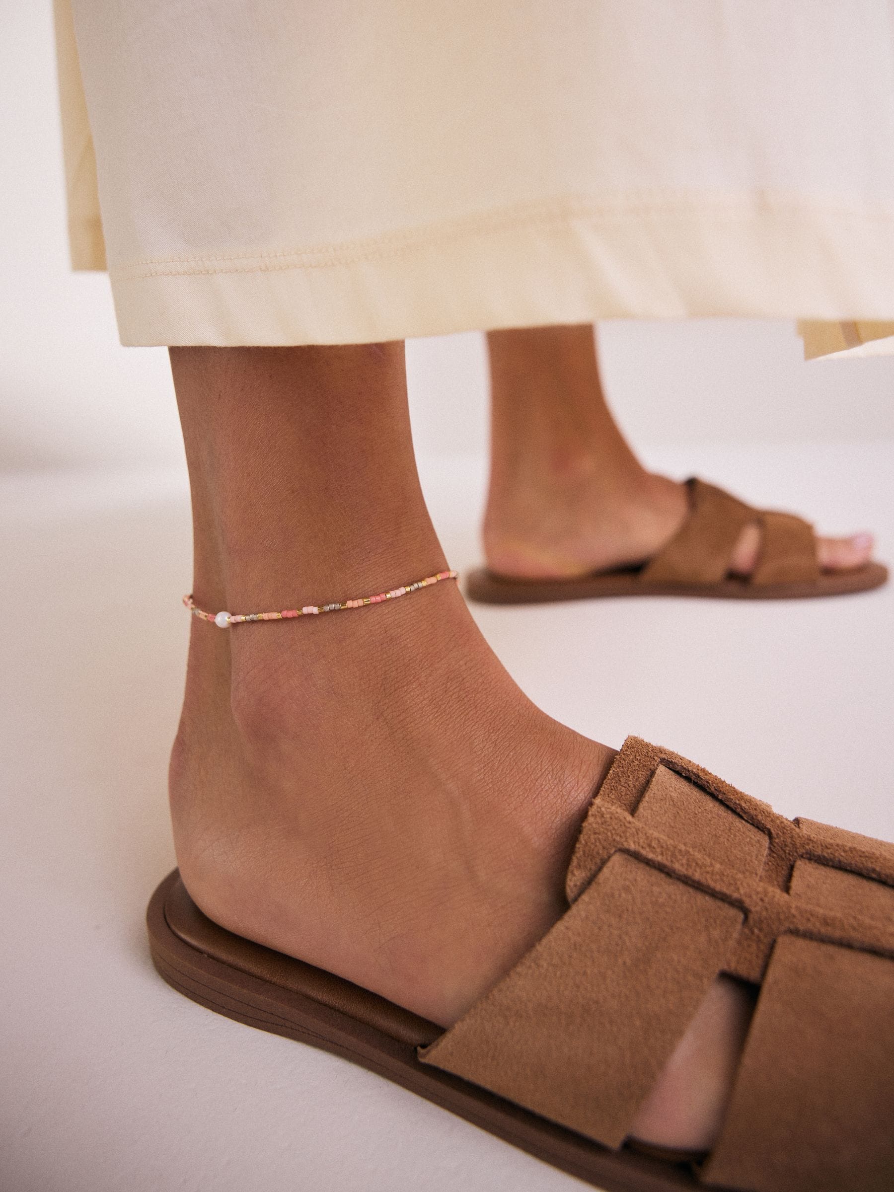 Orange beaded anklet, imported from the UK