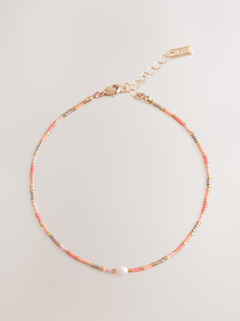 Orange beaded anklet, imported from the UK