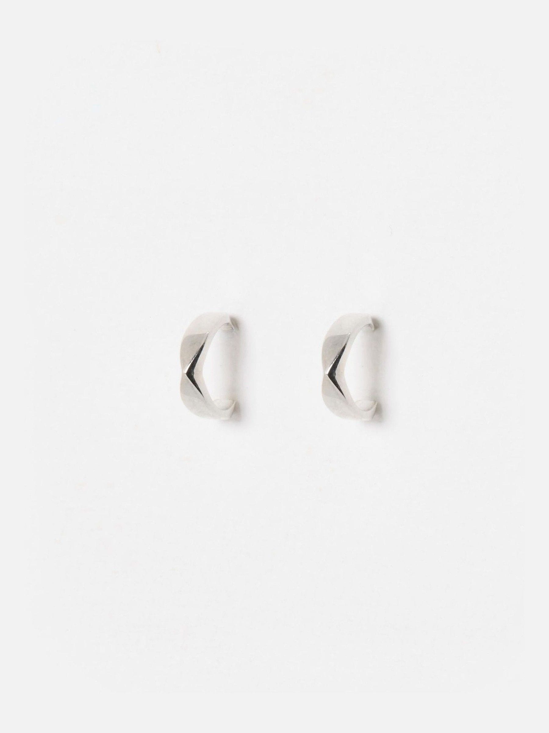 Oliver Bonas sterling silver huggie earrings with faceted surface, imported from the UK