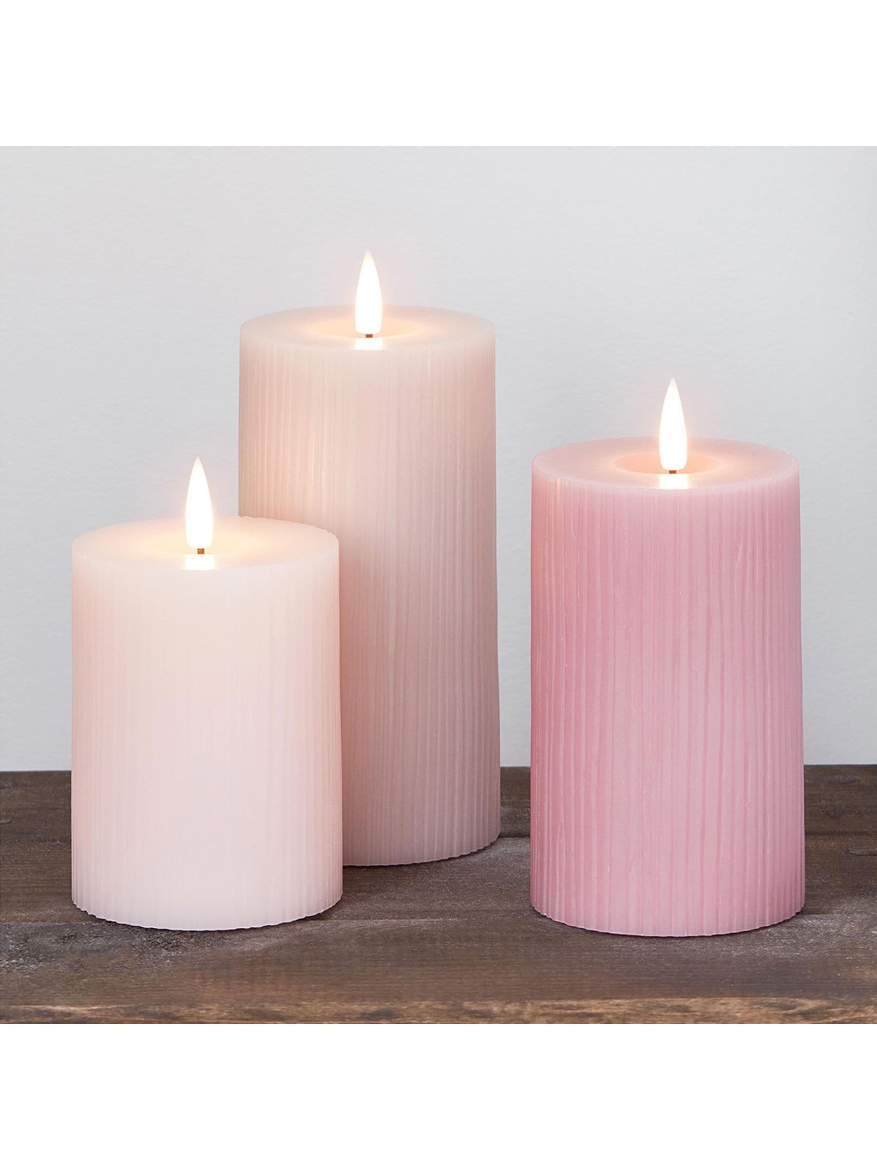 Lights4fun pink LED pillar candle trio with varying heights, UK version