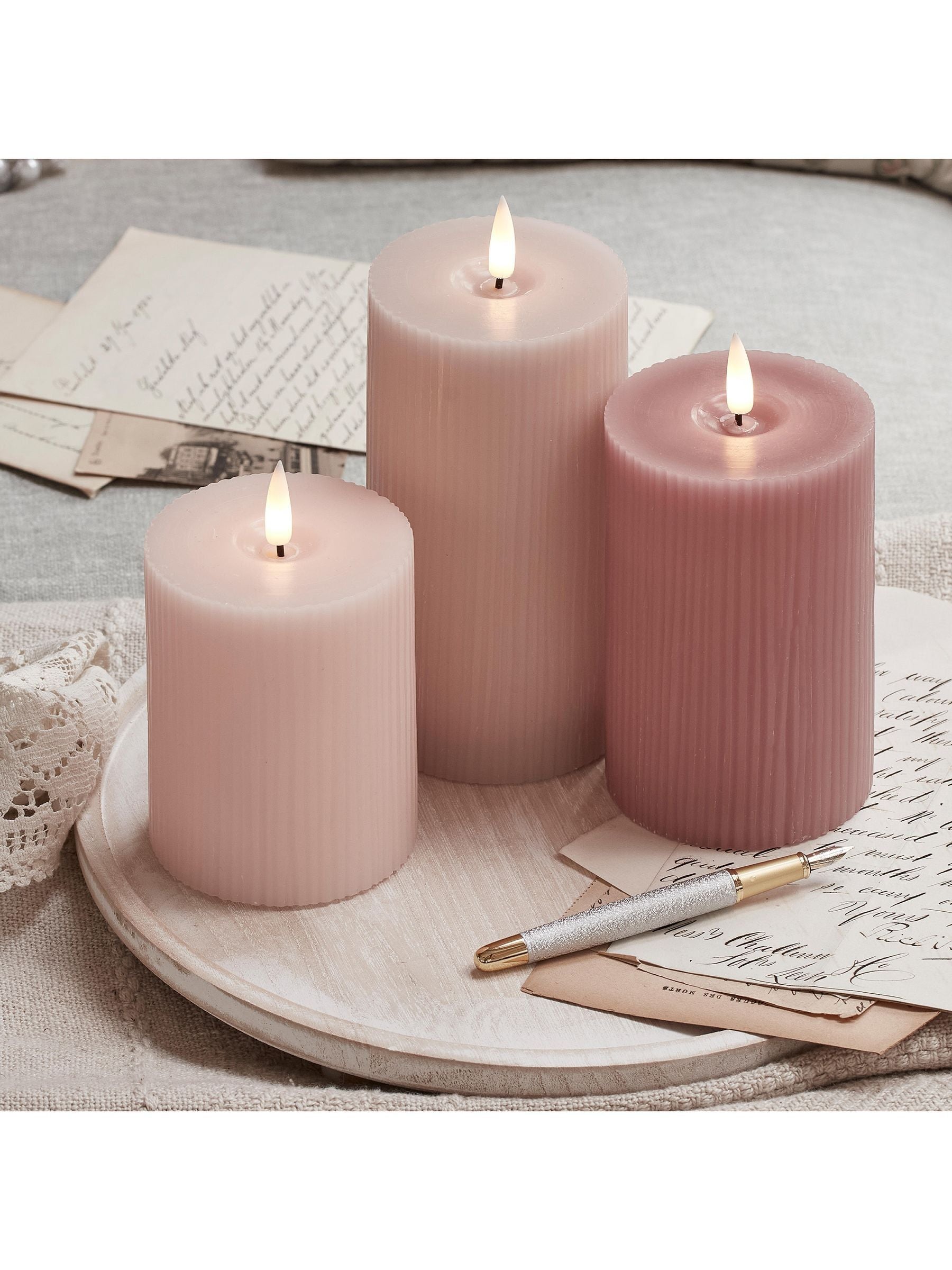 Lights4fun pink LED pillar candle trio with varying heights, UK version