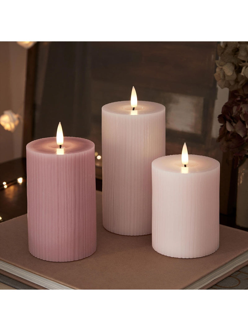 Lights4fun pink LED pillar candle trio with varying heights, UK version