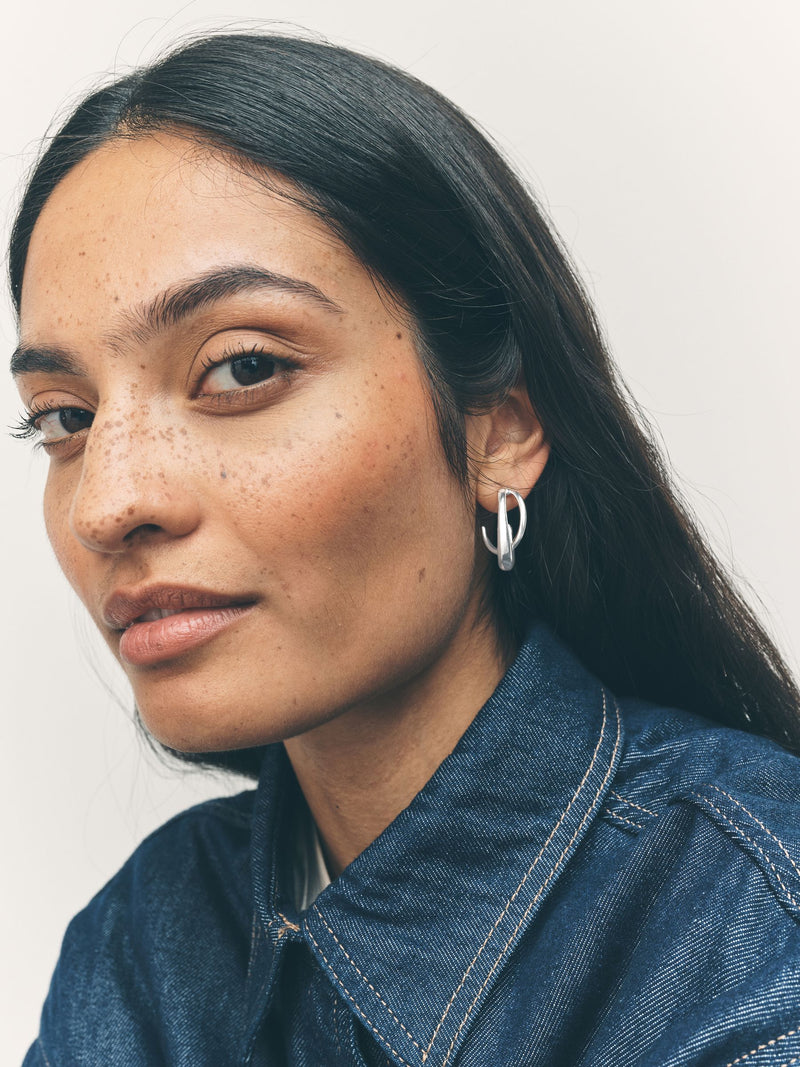 Silver tone crossover hoop earrings (British brand)