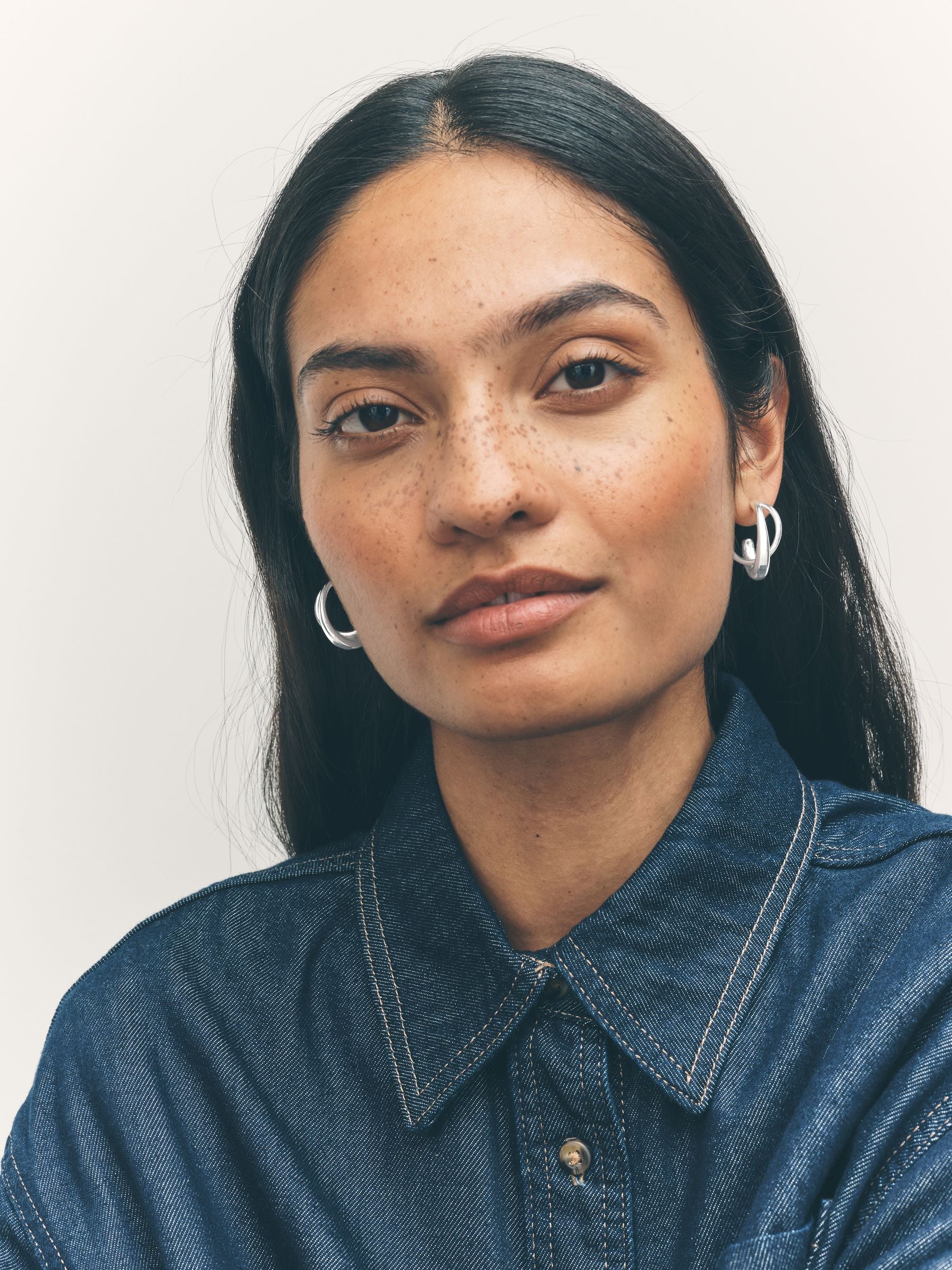 Silver tone crossover hoop earrings (British brand)
