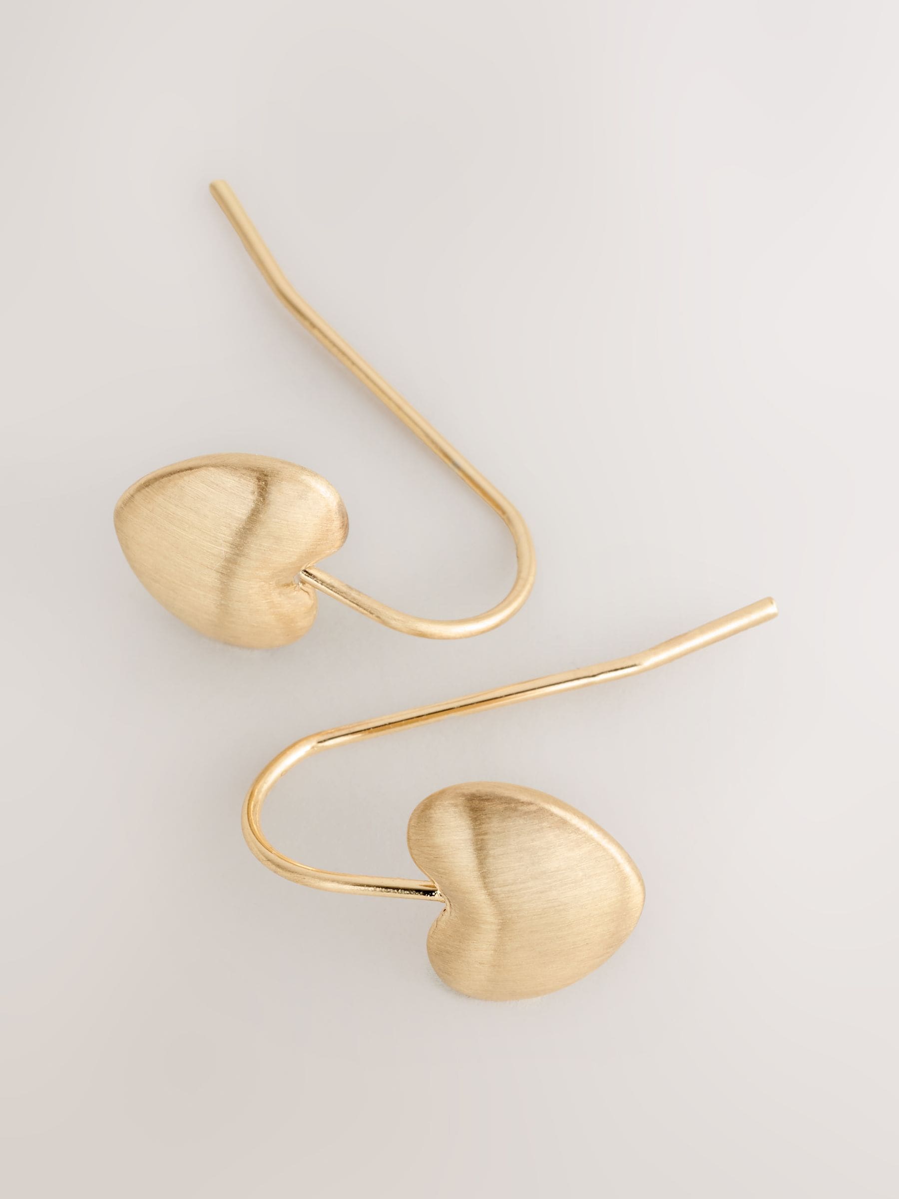 Brushed gold tone heart pierced earrings - British product