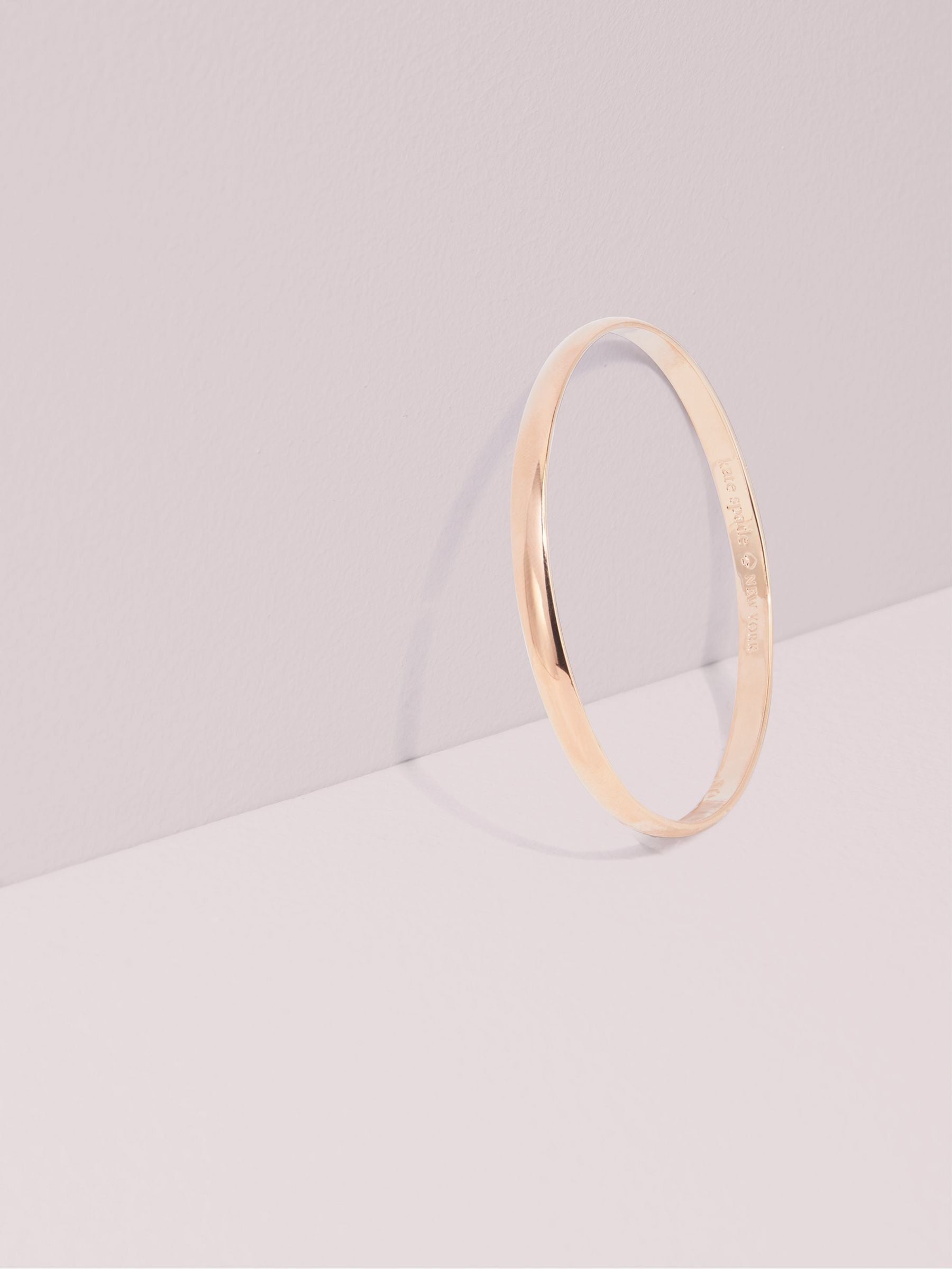 Kate Spade rose gold tone idiom bangle, UK version