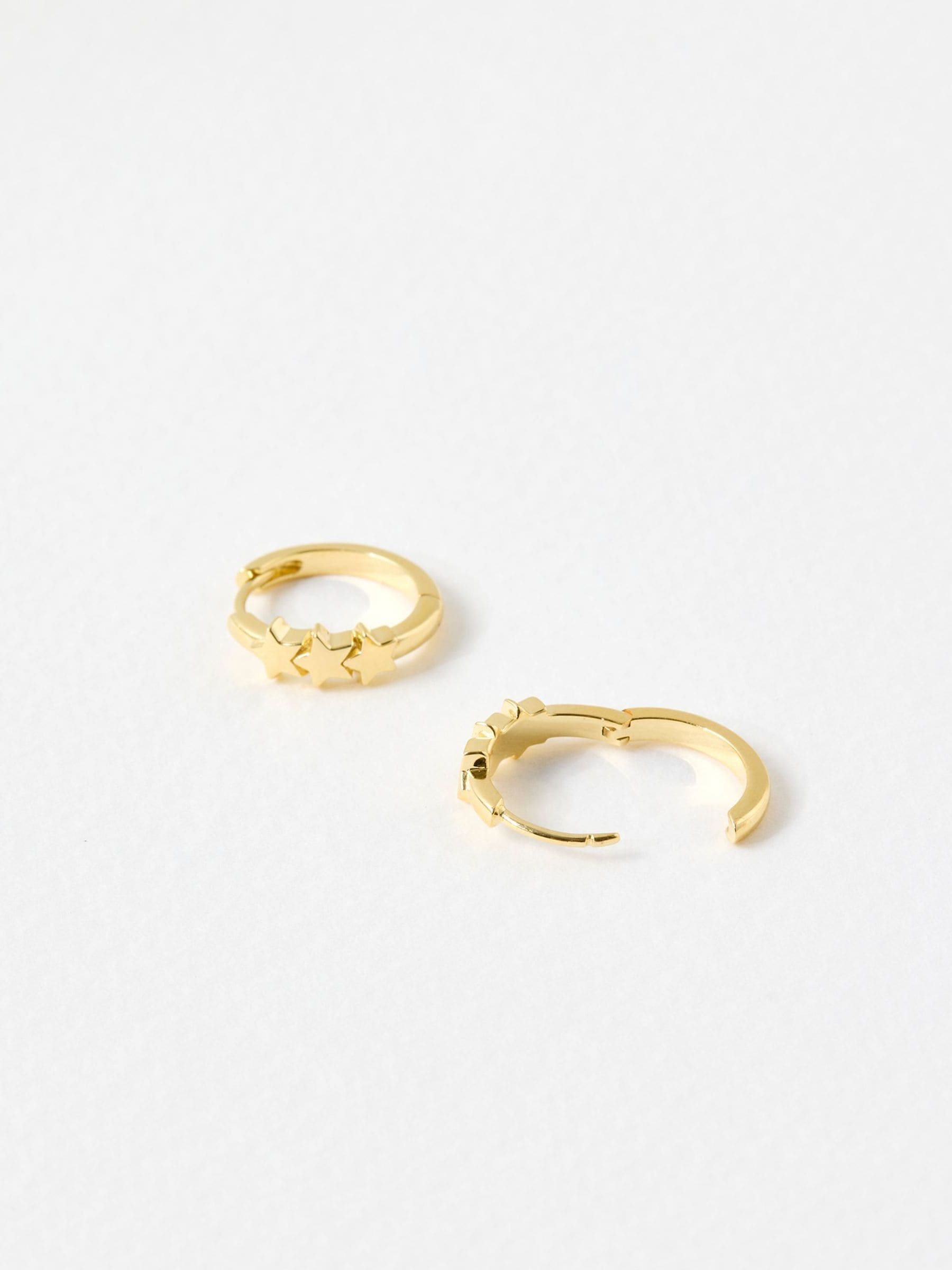 Oliver Bonas gold tone tiny triple star huggie earrings, imported from the UK