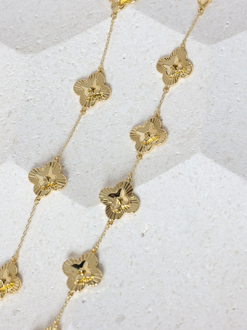 Inicio gold tone diamond cut clover station bracelet, UK version